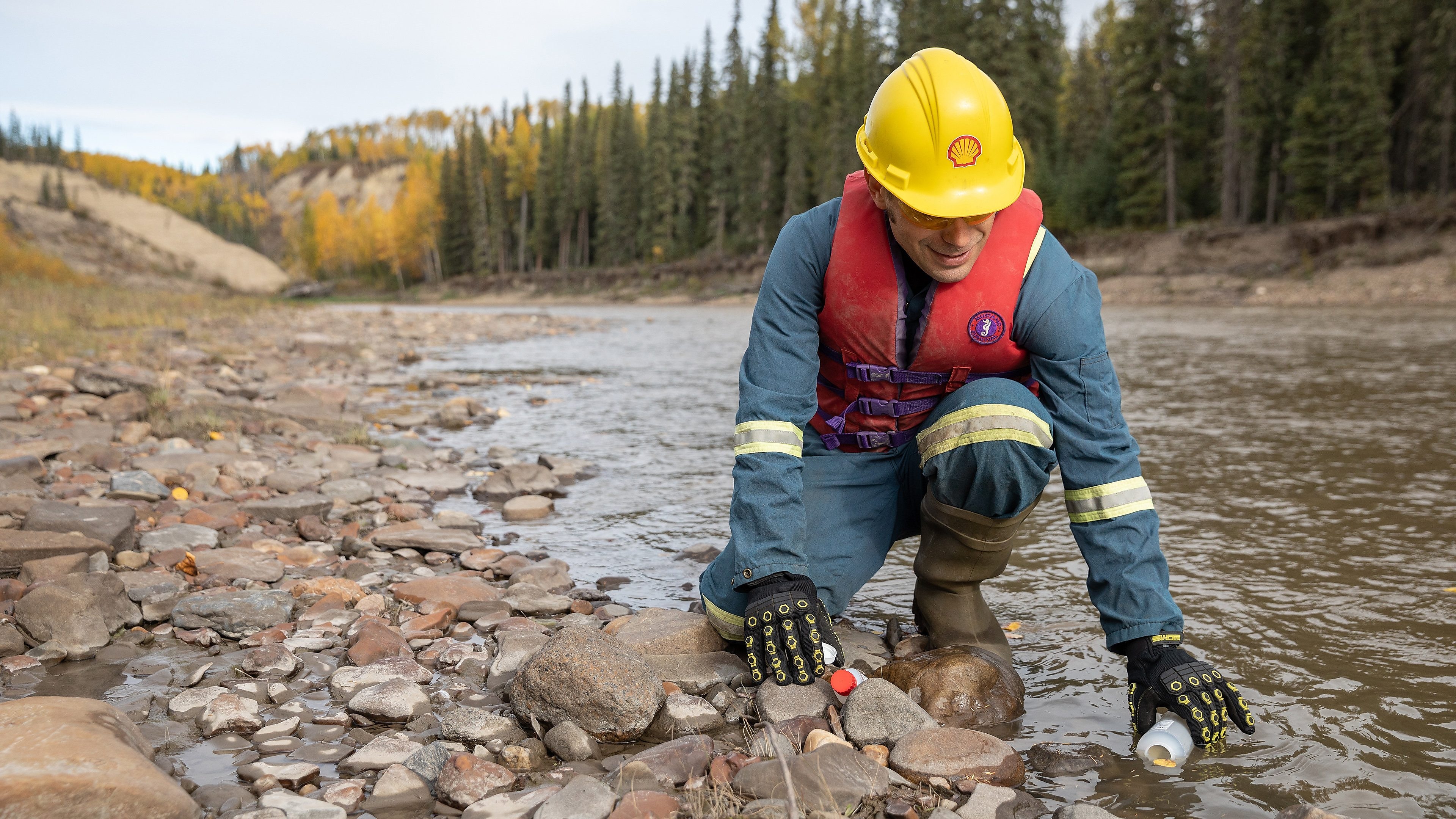 Shell employee gathering river water