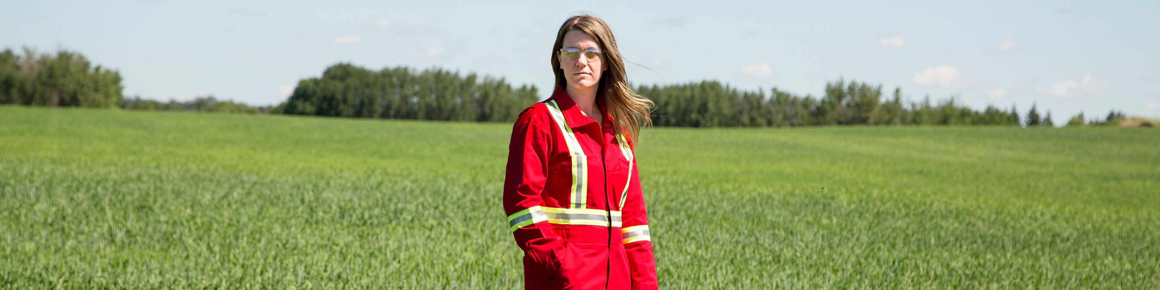 An employee stands in a field near a Quest C02 injection well northeast of Edmonton, Alberta in Canada